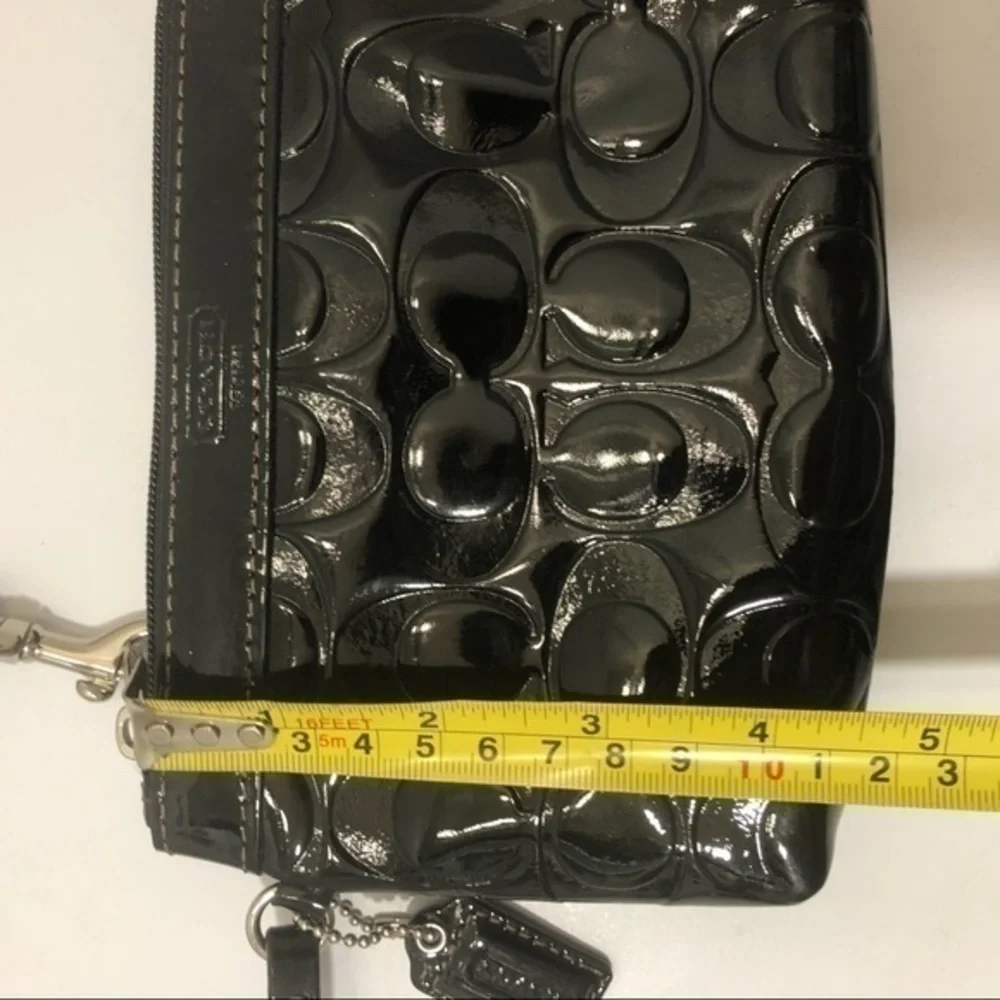 Coach embossed black leather wristlet clutch bag